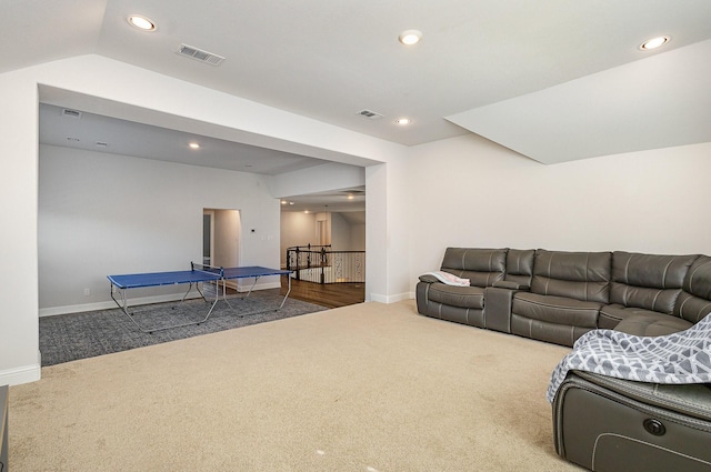 living room with lofted ceiling and carpet flooring