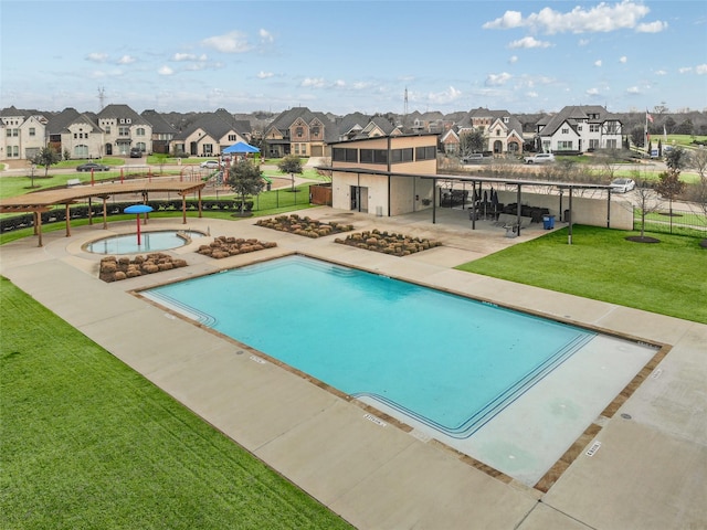 view of swimming pool with a hot tub, a pergola, a patio area, and a lawn