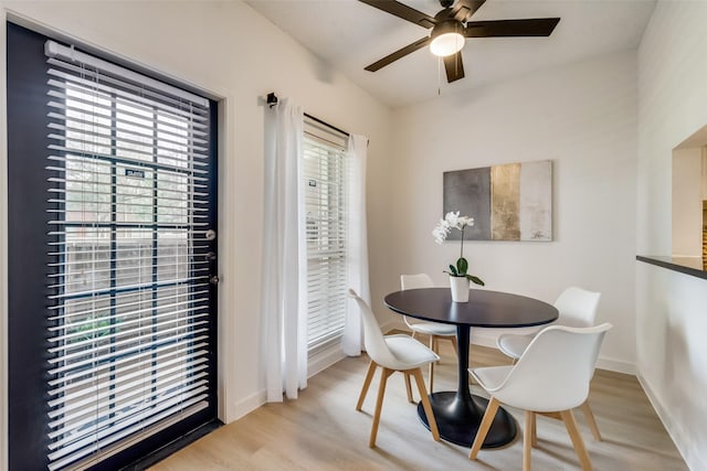 dining space featuring ceiling fan and light wood-type flooring