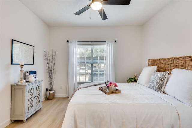 bedroom with ceiling fan and light hardwood / wood-style flooring