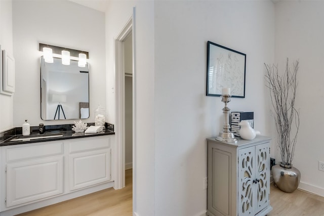 bathroom with vanity and wood-type flooring