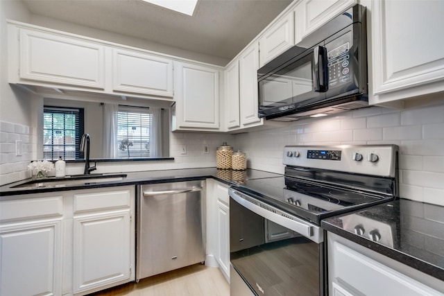 3639 W Northgate Dr Unit 150, Irving, TX 75062 - kitchen featuring stainless steel appliances, a sink, decorative backsplash, and white cabinets