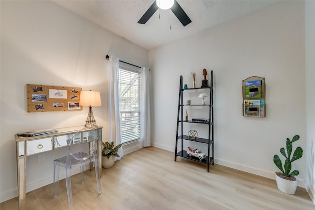 home office with hardwood / wood-style floors, a textured ceiling, and ceiling fan