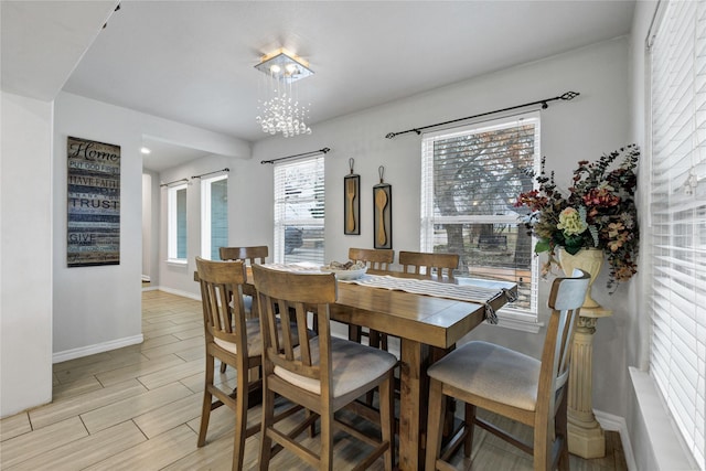 dining space featuring an inviting chandelier and a barn door