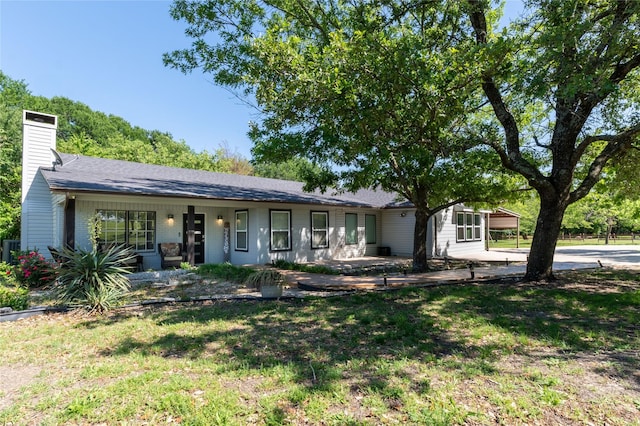 1435 Pioneer Ln, Lowry Crossing, TX 75069 - ranch-style house with a chimney, brick siding, and a front yard