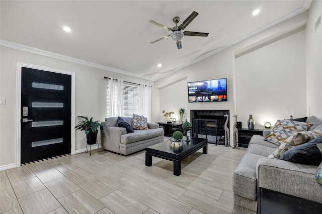 living room featuring ceiling fan, ornamental molding, and vaulted ceiling