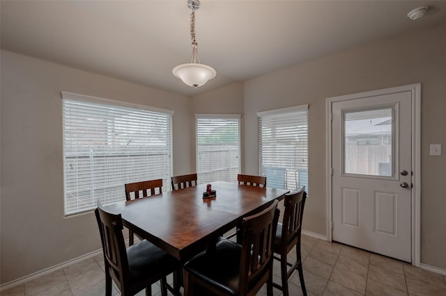 tiled dining room with vaulted ceiling