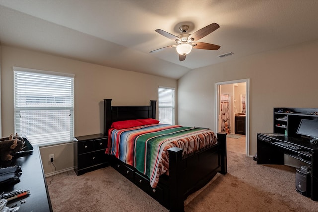 carpeted bedroom with ceiling fan, lofted ceiling, and ensuite bathroom