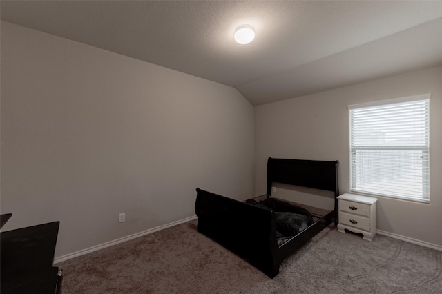 carpeted bedroom with lofted ceiling