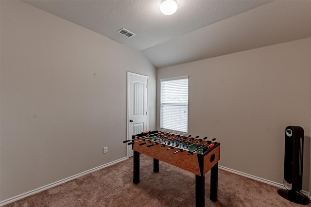 playroom featuring lofted ceiling, carpet floors, and a textured ceiling