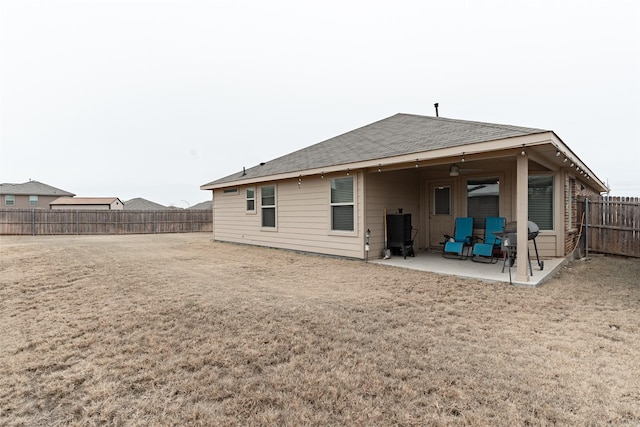 rear view of house with ceiling fan and a patio area