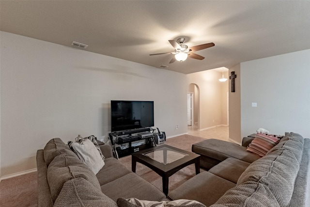 living room featuring light carpet and ceiling fan