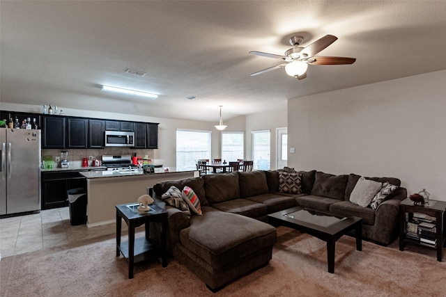 tiled living room featuring ceiling fan