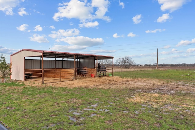 view of outbuilding featuring a rural view, an outdoor structure, and an exterior structure