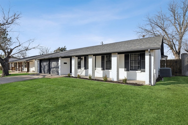 single story home featuring cooling unit and a front yard