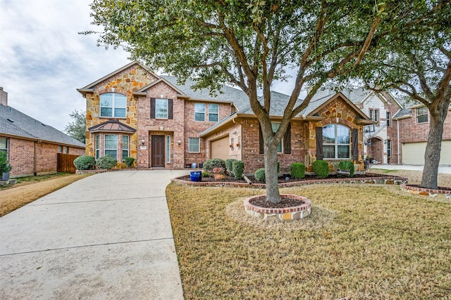 view of front of house with a garage and a front yard