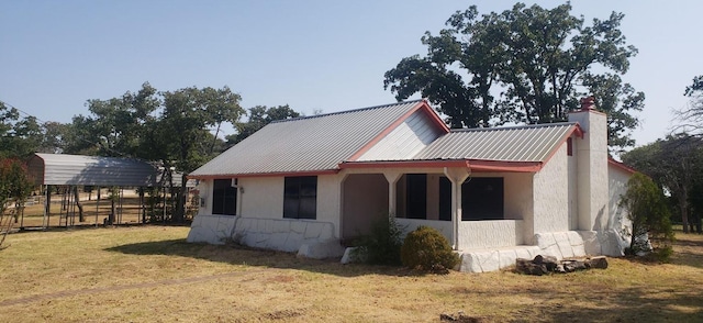 view of property exterior featuring a carport and a yard