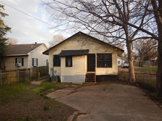 rear view of house featuring cooling unit and a patio area