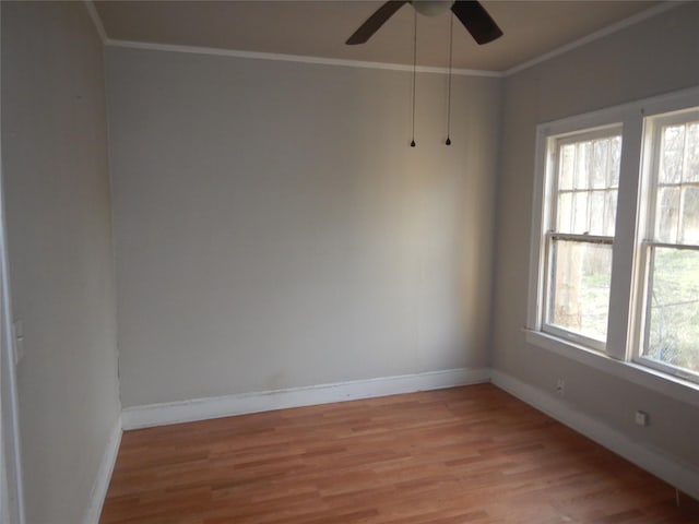 spare room featuring ceiling fan, ornamental molding, and light hardwood / wood-style floors