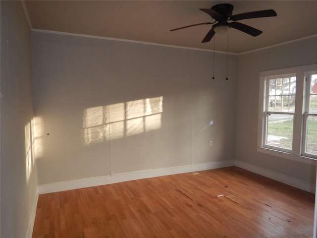 empty room featuring hardwood / wood-style flooring, crown molding, and ceiling fan