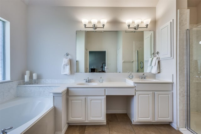 bathroom featuring shower with separate bathtub, tile patterned floors, and vanity