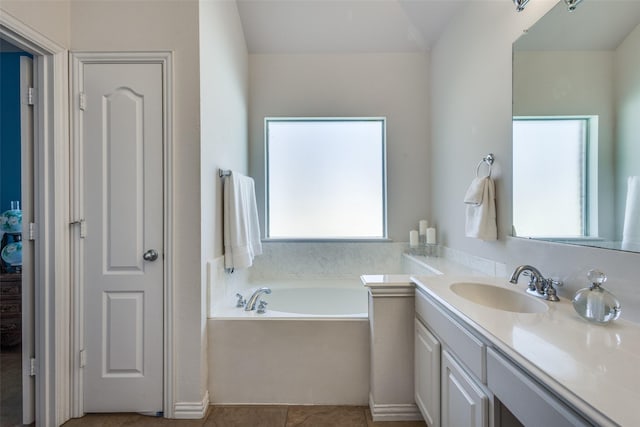 bathroom featuring tile patterned flooring, vanity, and a bathing tub