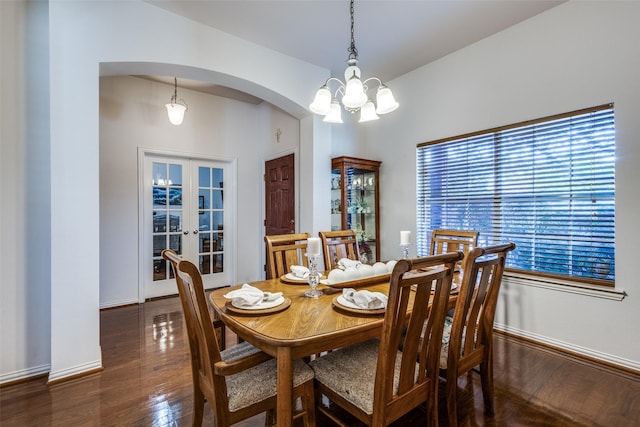 dining room featuring french doors, dark hardwood / wood-style floors, and a notable chandelier