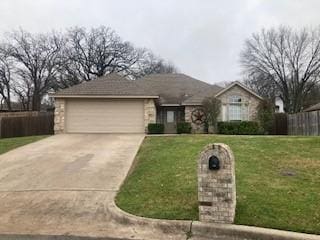 single story home with a garage and a front yard