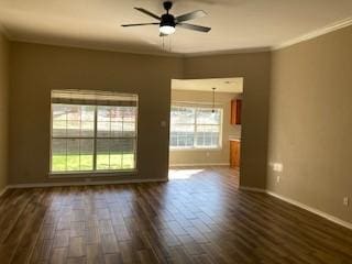 spare room with dark hardwood / wood-style flooring, ornamental molding, and ceiling fan