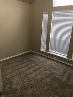 carpeted empty room with lofted ceiling