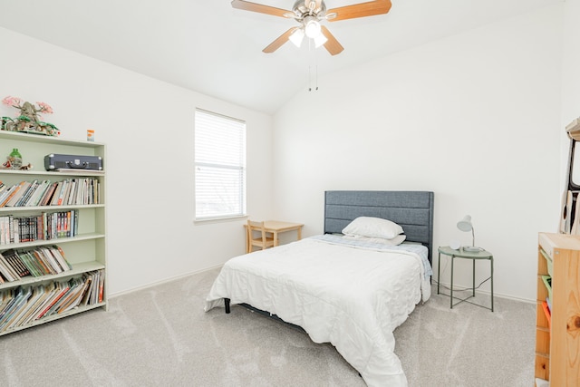 carpeted bedroom with vaulted ceiling and ceiling fan