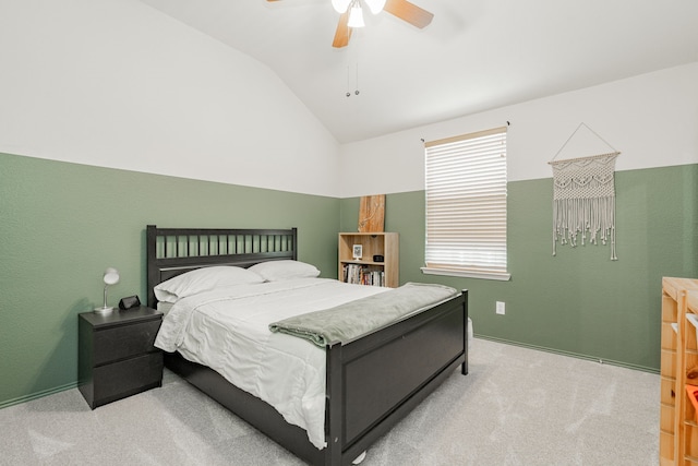 bedroom with vaulted ceiling, ceiling fan, and carpet