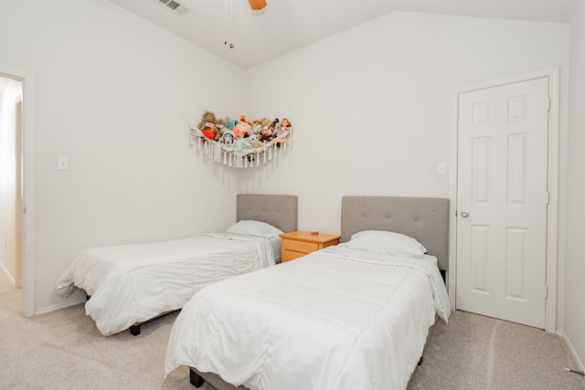 carpeted bedroom with vaulted ceiling and ceiling fan