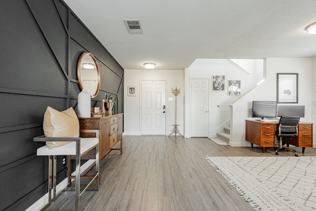 office with hardwood / wood-style flooring and a textured ceiling