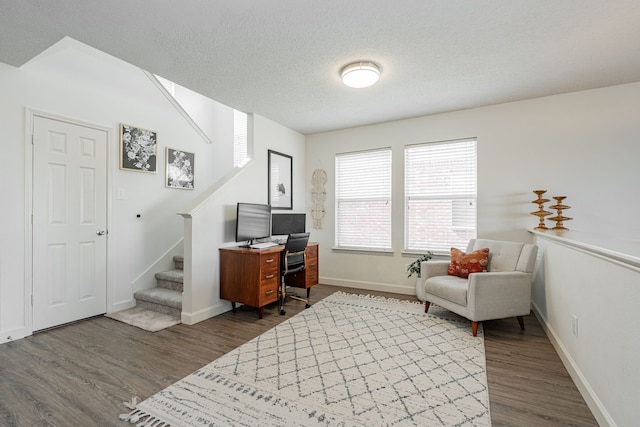 home office featuring dark hardwood / wood-style floors and a textured ceiling