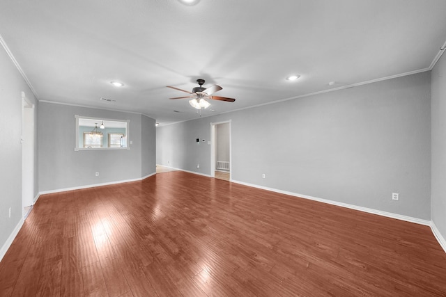 spare room with crown molding, wood-type flooring, and ceiling fan