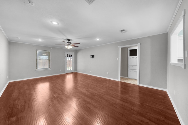 empty room featuring hardwood / wood-style flooring, ceiling fan, and ornamental molding