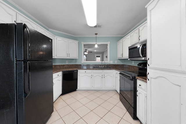 kitchen with sink, light tile patterned floors, black appliances, and white cabinets