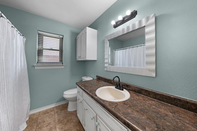 bathroom with vanity, tile patterned floors, and toilet