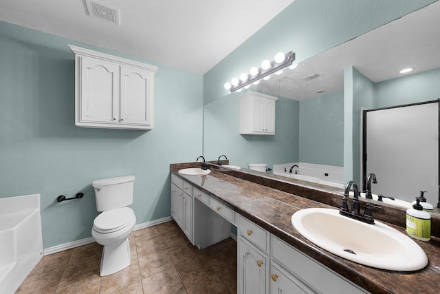 bathroom featuring tile patterned flooring, vanity, a washtub, and toilet