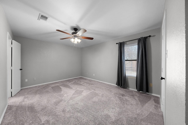 unfurnished room featuring light carpet and ceiling fan