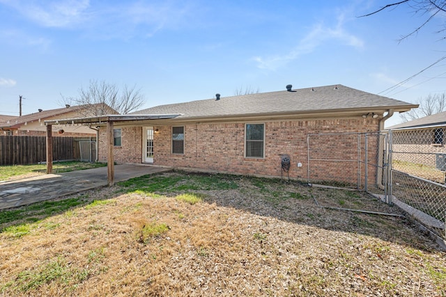 rear view of house featuring a patio and a lawn