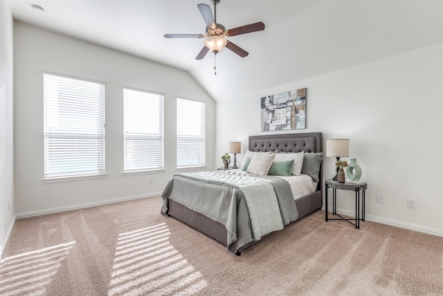 carpeted bedroom with baseboards, lofted ceiling, and a ceiling fan