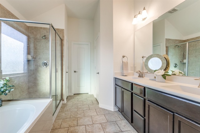 full bath with a shower stall, a bath, vaulted ceiling, and a sink