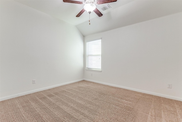 empty room featuring visible vents, light carpet, lofted ceiling, baseboards, and ceiling fan