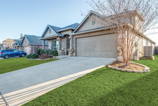 single story home featuring brick siding, concrete driveway, a front yard, central AC unit, and a garage