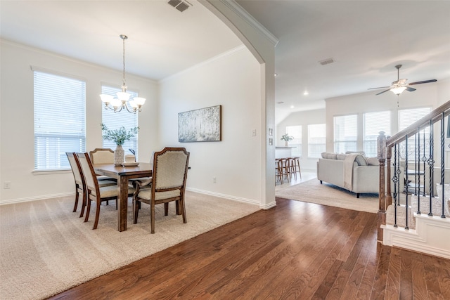 dining area with a wealth of natural light, visible vents, ornamental molding, and wood finished floors