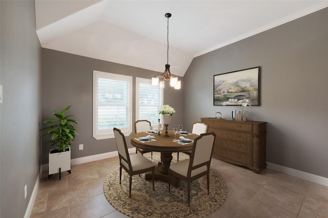 dining area featuring a chandelier, vaulted ceiling, and baseboards