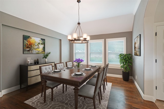 dining room featuring vaulted ceiling, baseboards, wood finished floors, and an inviting chandelier