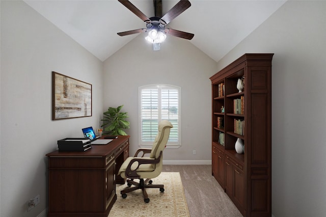 home office featuring vaulted ceiling, baseboards, a ceiling fan, and light colored carpet